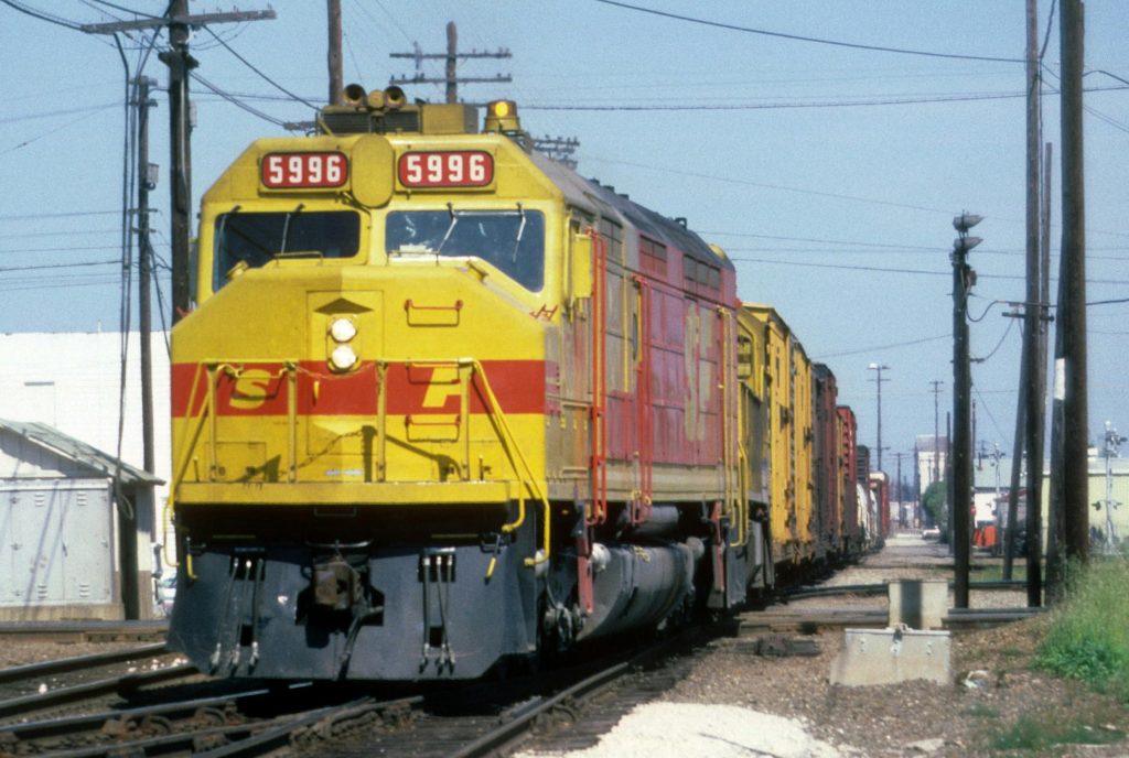 A colorful freight train moves along tracks in Stockton, California.